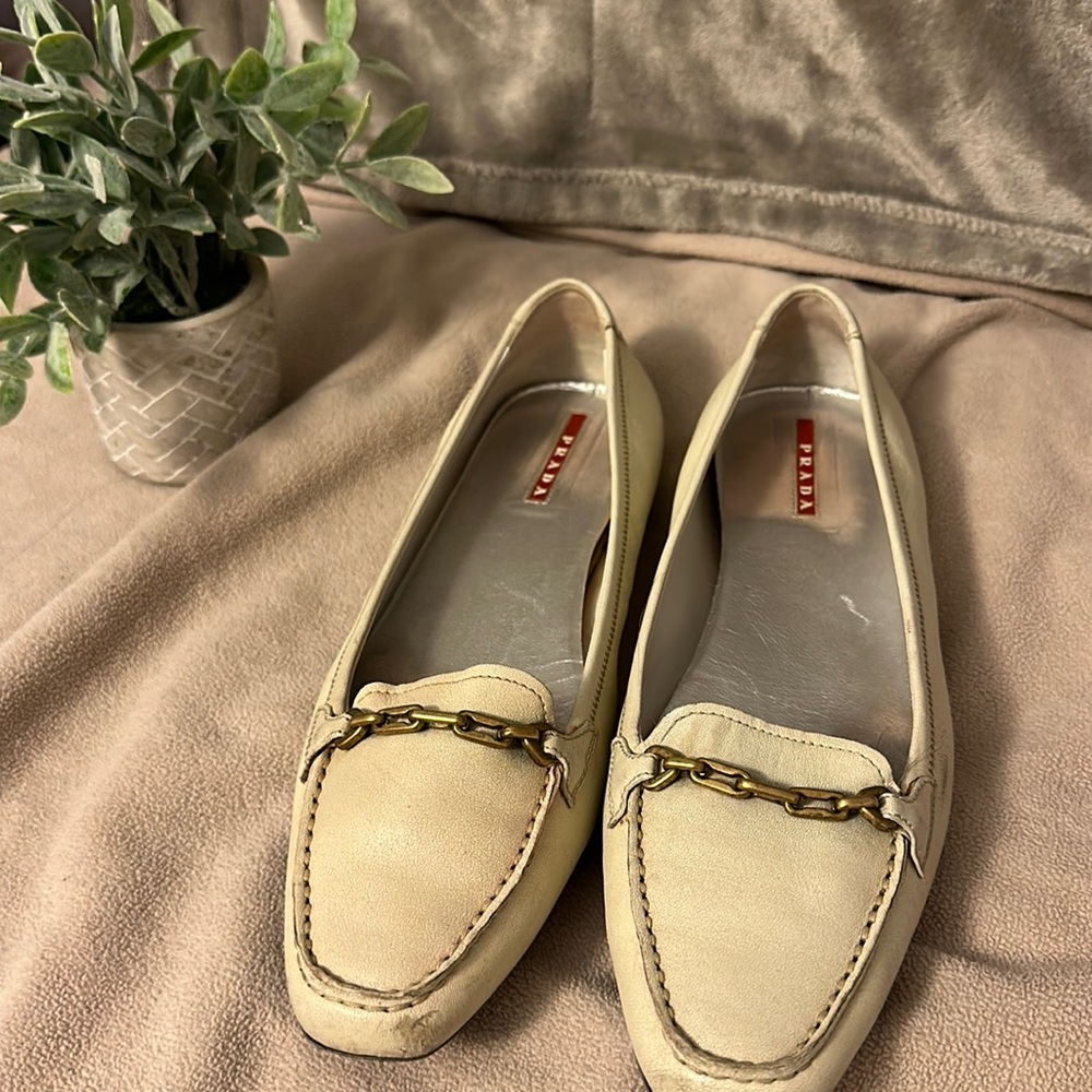 PRADA IVORY FLATS WITH GOLD DETAILING